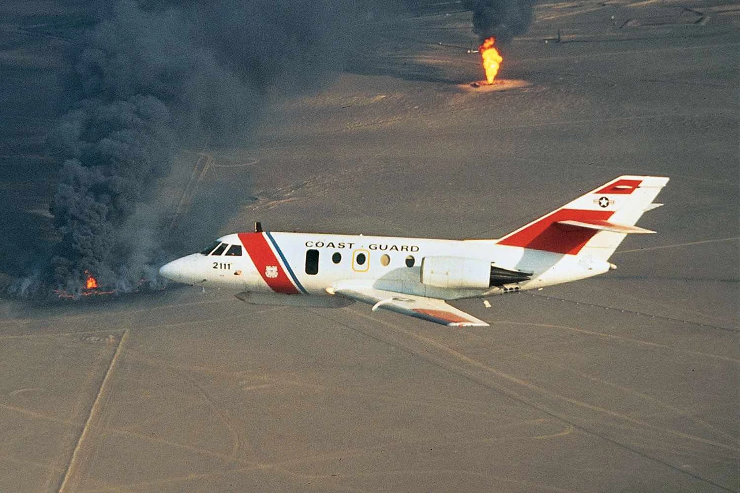 US Coast Guard HU-25 flying over burning oil wells in Iraq during the Gulf War (Dassault)