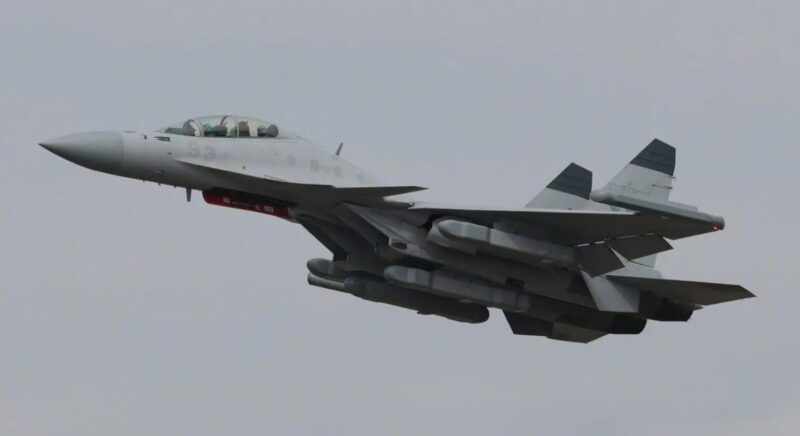 Caça Shenyang J-15D em voo durante o Zhuhai Air Show 2024. Pods de guerra eletrônica são claramente visíveis sob as asas e fuselagem central.